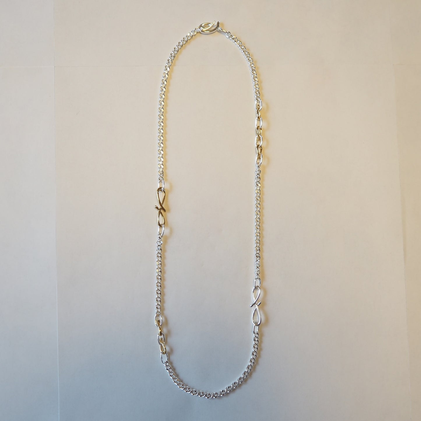 
                  
                    Turning Motif Chain Necklace 
                  
                